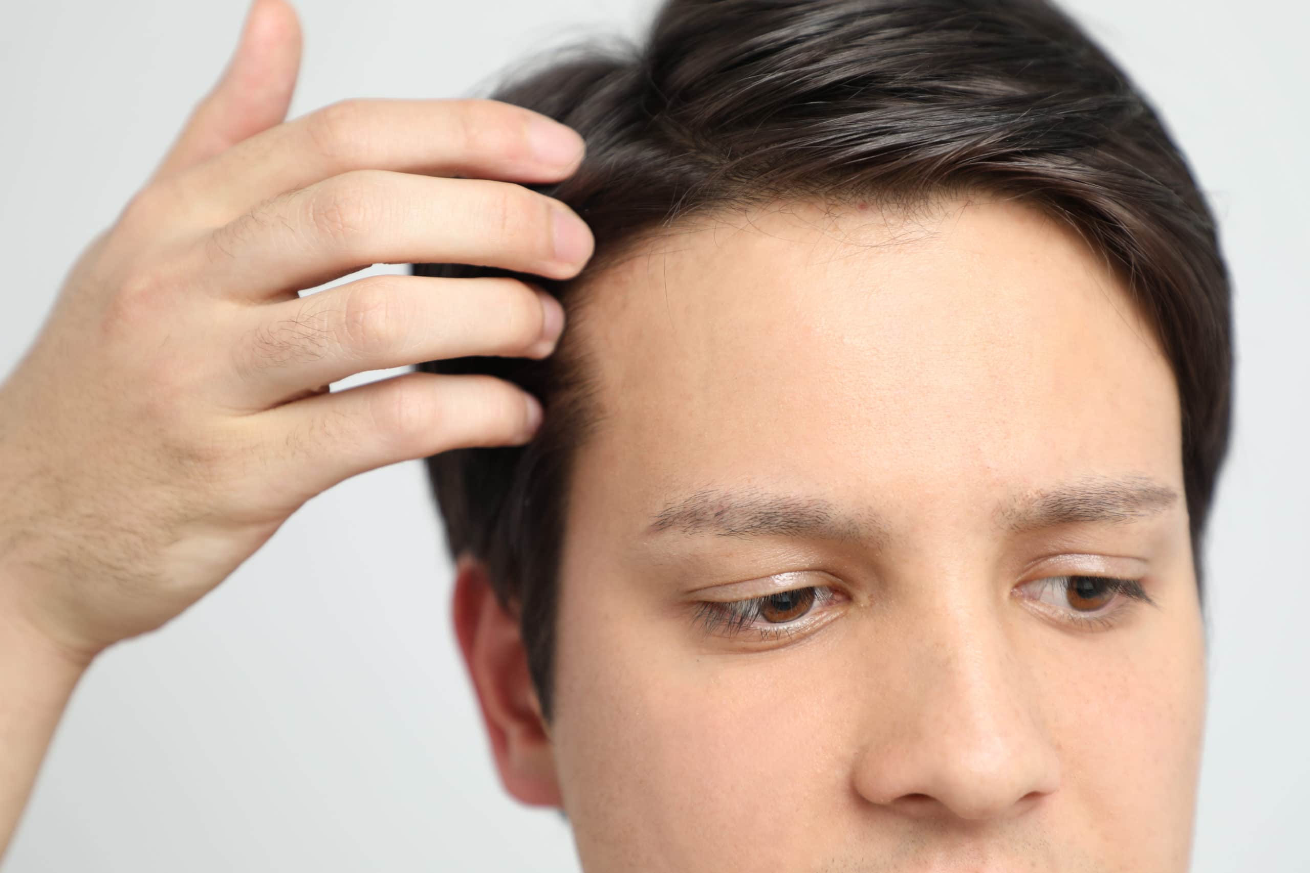 Man touching full head of hair