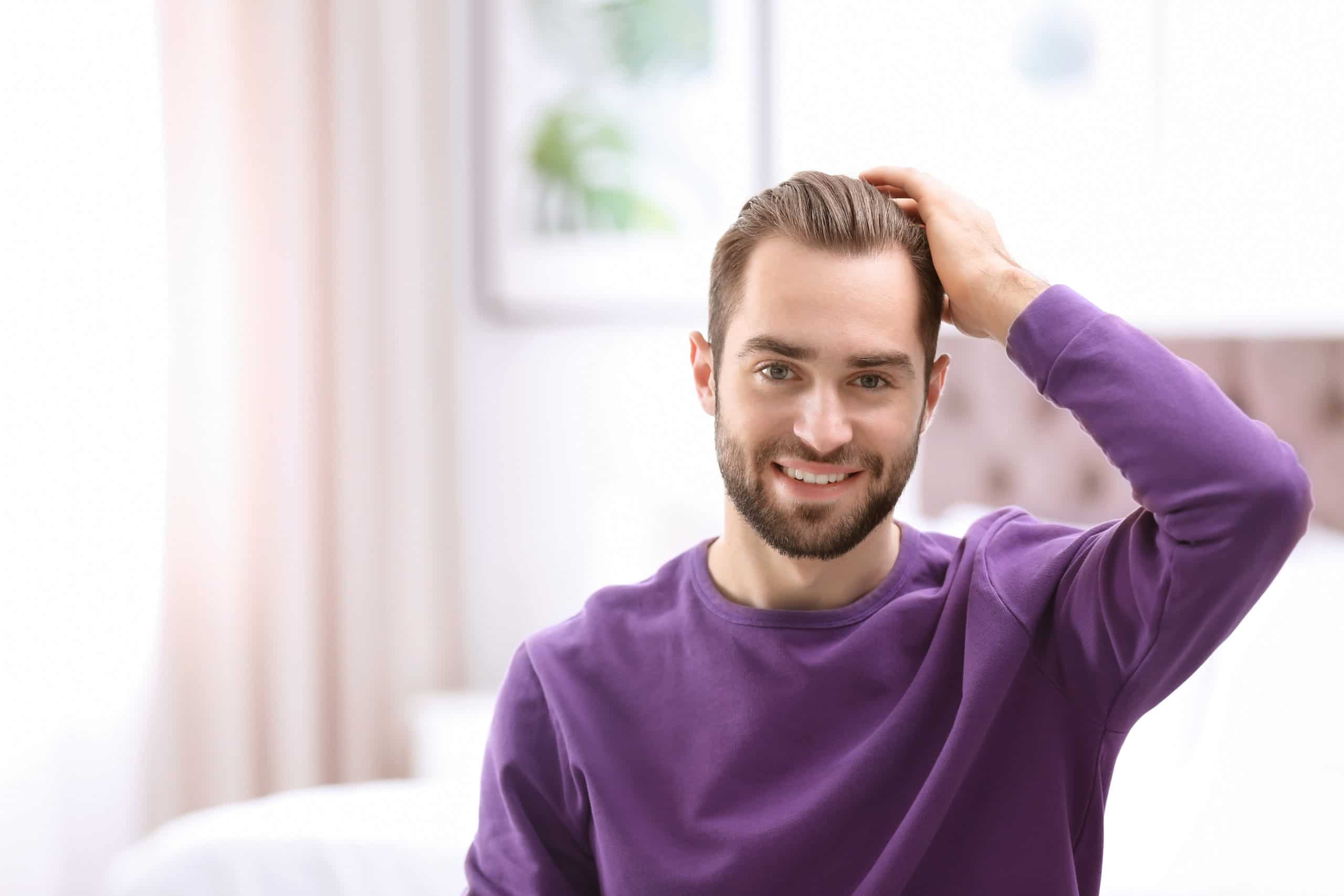 Portrait of young man with beautiful hair indoors