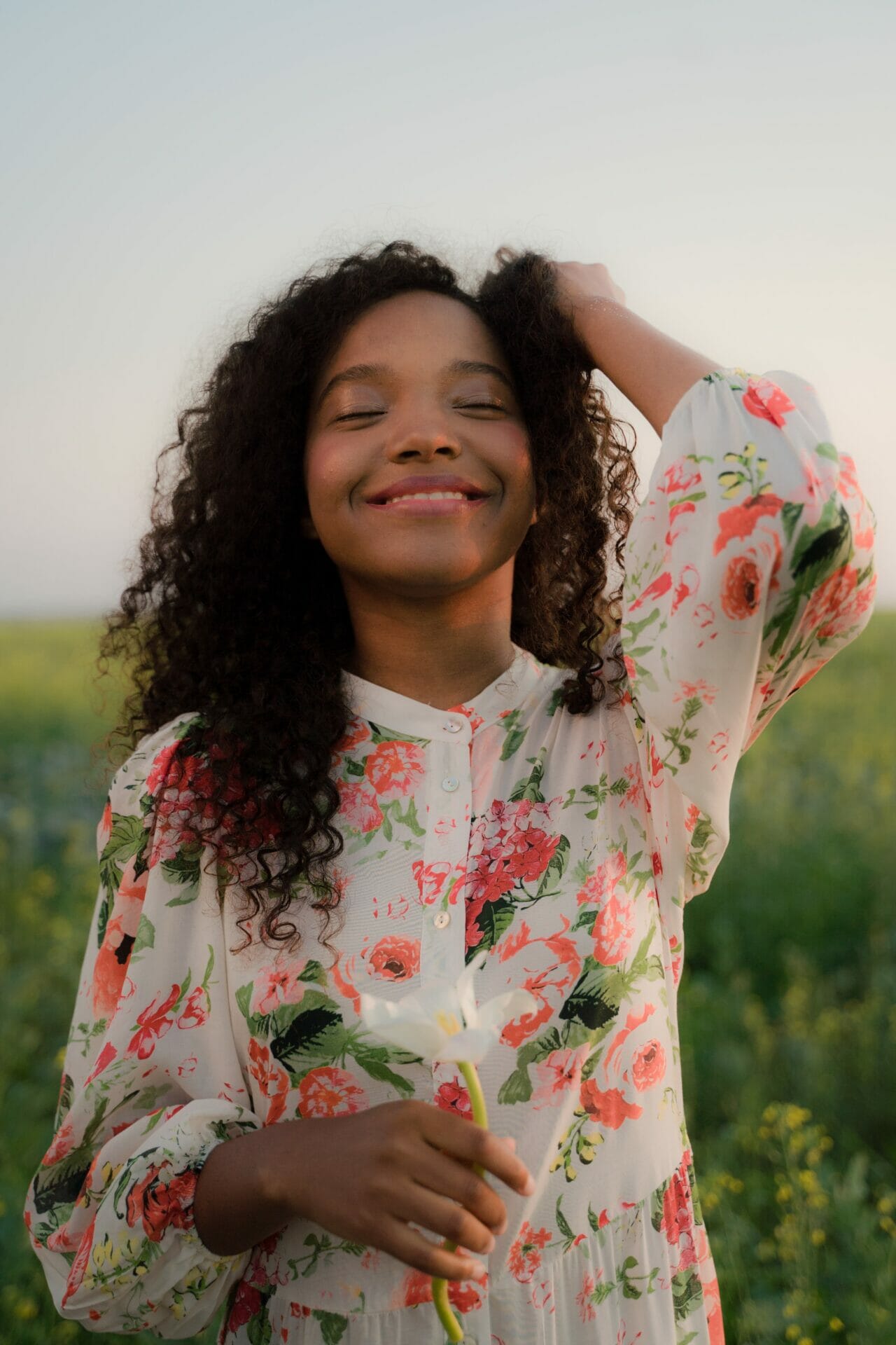 woman with long curly hair smiling